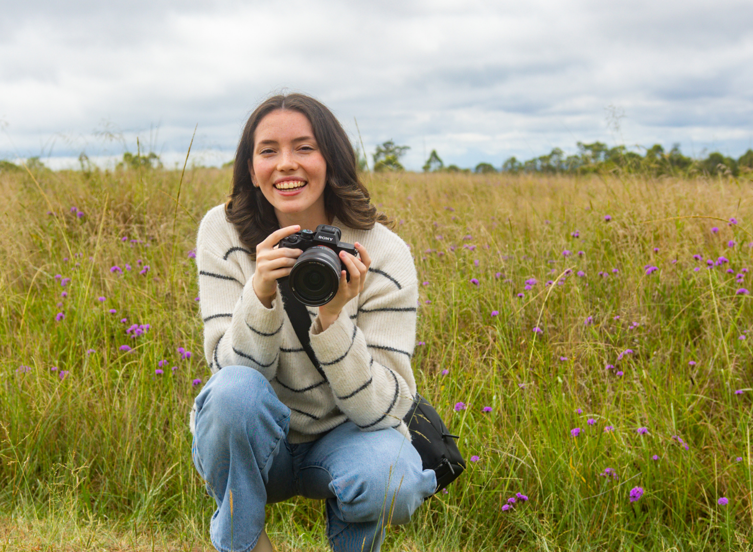 Ilana Eden holding a camera in a field